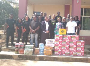 Staff representatives from Access Bank with Staff representatives from HVCF posing beside items donated by Access Bank Staff.