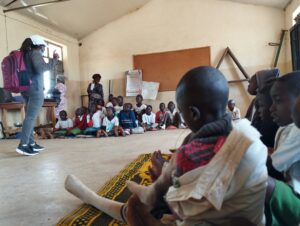 HVCF Team Member Coaching Members of the Peace Club on the need for good health practices and good morals.